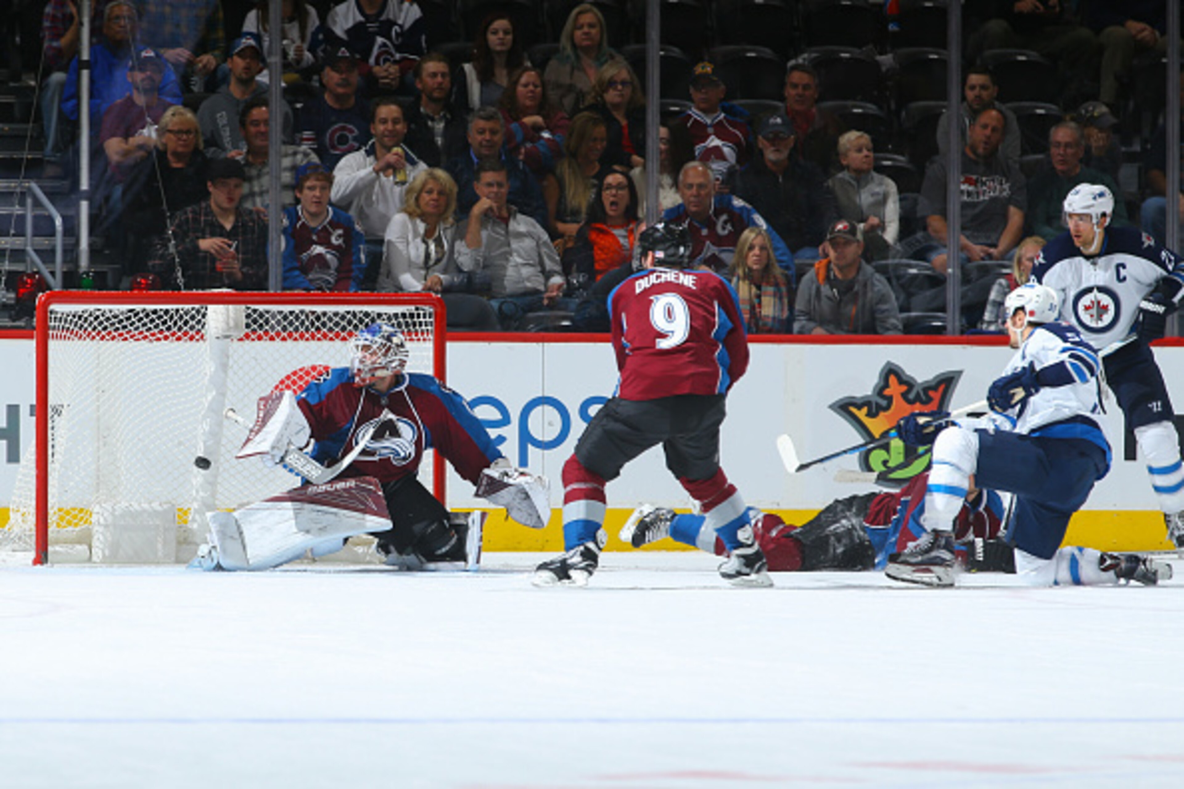 DENVER, CO - NOVEMBER 11:  Mark Scheifele #55 of the Winnipeg Jets scores a power play goal past Semyon Varlamov #1 of the Colorado Avalanche off of an assist from Blake Wheeler #26 as Matt Duchene #9 looks on during the second period at Pepsi Center on N
