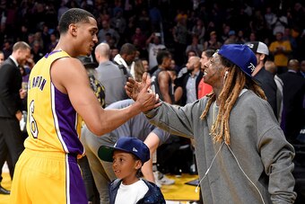 LOS ANGELES, CA - NOVEMBER 15:  Rapper Lil Wayne shakes hands with Jordan Clarkson #6 of the Los Angeles Lakers during a during a 125-118 Laker win over the Brooklyn Nets at Staples Center on November 15, 2016 in Los Angeles, California.  NOTE TO USER: Us