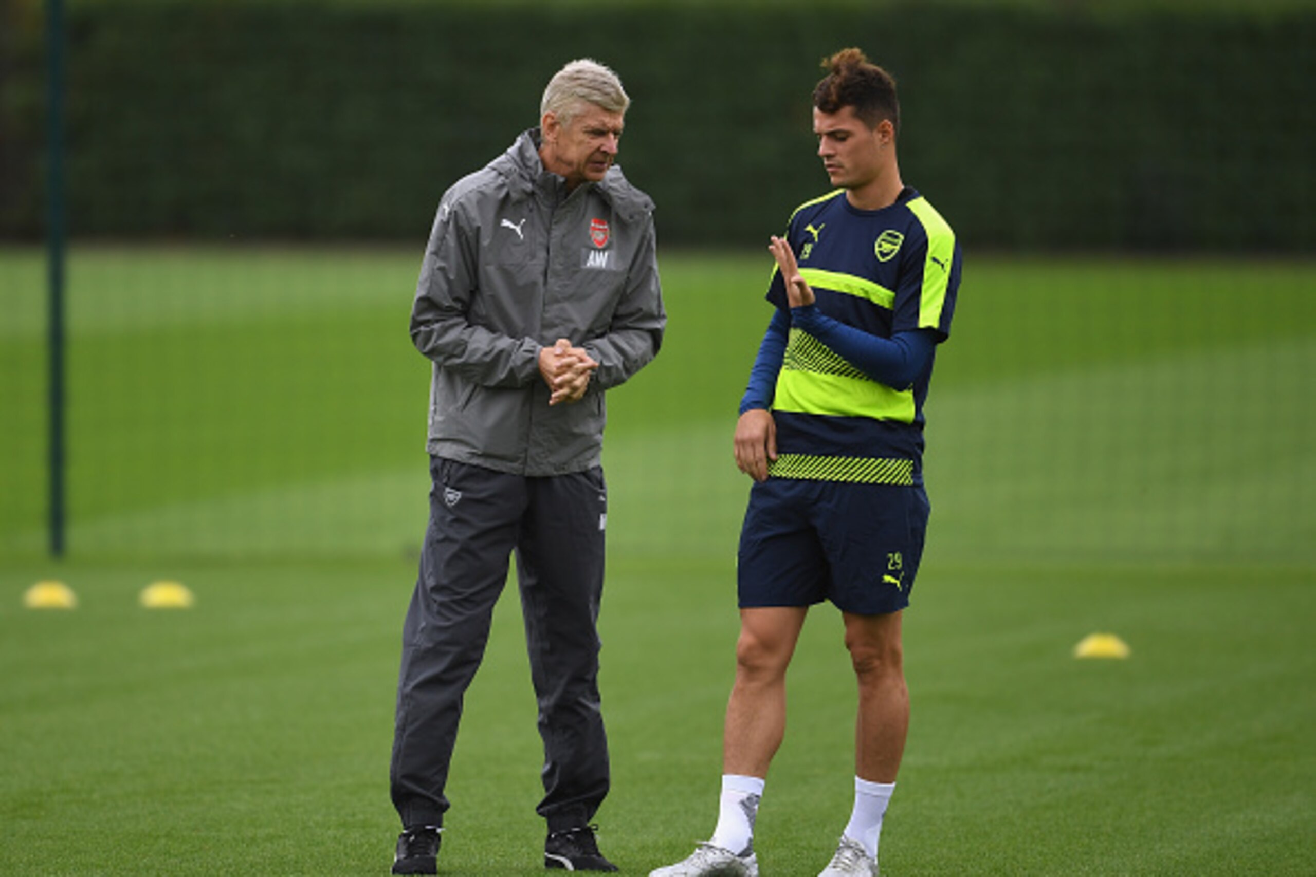 ST ALBANS, ENGLAND - SEPTEMBER 27:  Manager Arsene Wenger of Arsenal talks to Granit Xhaka during an Arsenal training session ahead of the Champions League Group A match between Arsenal and Basel at London Colney on September 27, 2016 in St Albans, Englan