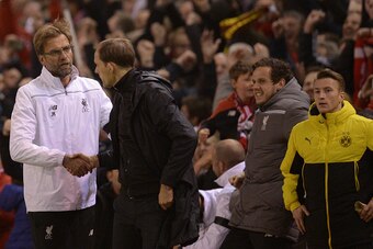 Liverpool's German manager Jurgen Klopp (L) shakes hands with Dortmund's head coach Thomas Tuchel after winning the UEFA Europa league quarter-final second leg football match between Liverpool  and Borussia Dortmund at Anfield stadium in Liverpool on Apri