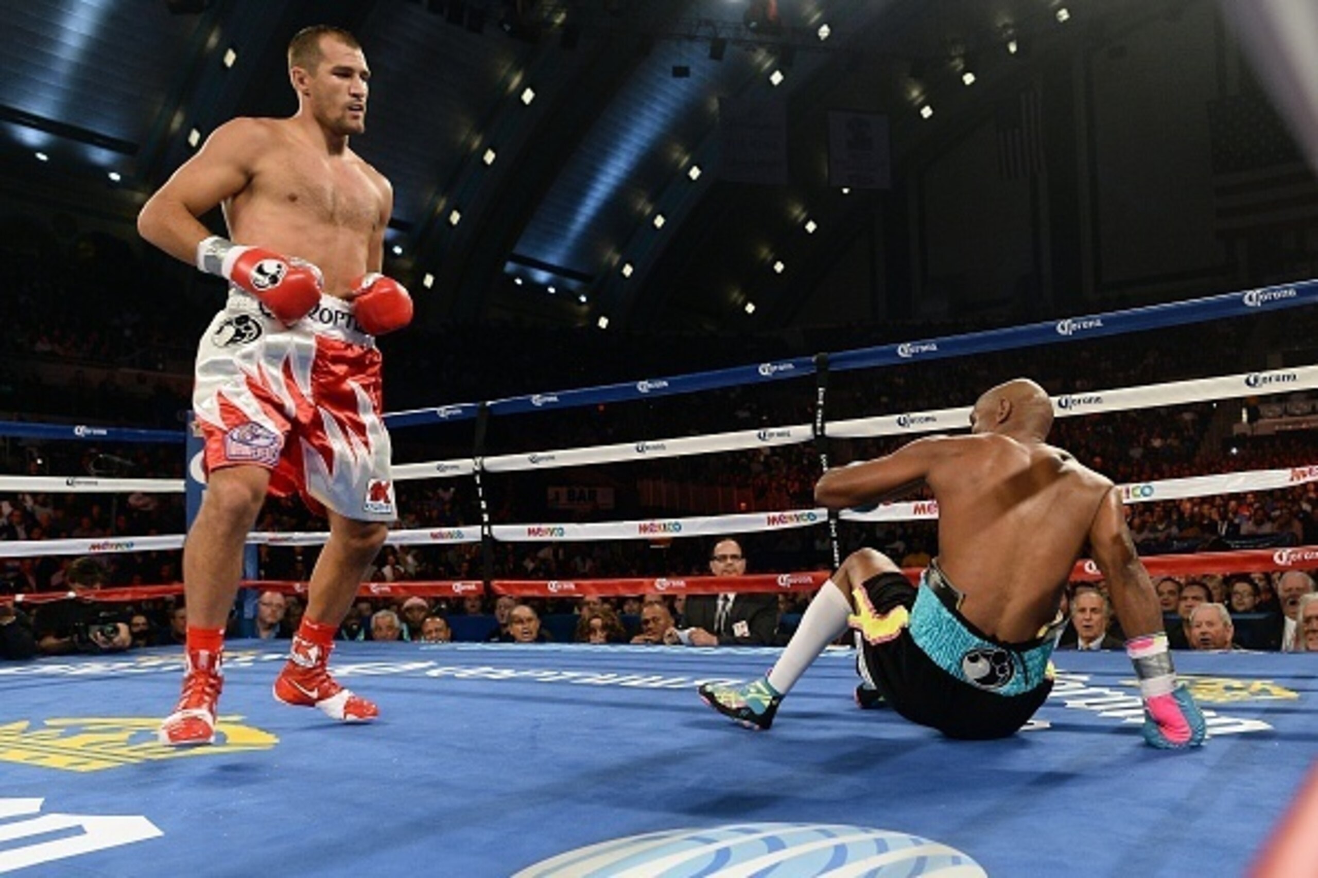 Bernard Hopkins (R) of the US is knocked down as he fights against Sergey Kovalev of Russia during their IBF, WBA and WBO light heavyweight title bout at the Boardwalk Hall in Atlantic City, New Jersey, on November 8, 2014. Kovalev defeated Hopkins. AFP P