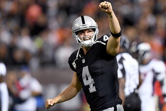 OAKLAND, CA - NOVEMBER 06:  Derek Carr #4 of the Oakland Raiders celebrates after they scored a touchdown against the Denver Broncos in the second quarter of an NFL football game at the Oakland-Alameda County Coliseum on November 6, 2016 in Oakland, Calif