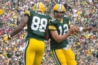 Sep 15, 2013; Green Bay, WI, USA;  Green Bay Packers tight end Jermichael Finley (88) and quarterback Aaron Rodgers (12) celebrate a touchdown during the second quarter against the Washington Redskins at Lambeau Field. Mandatory Credit: Jeff Hanisch-USA T
