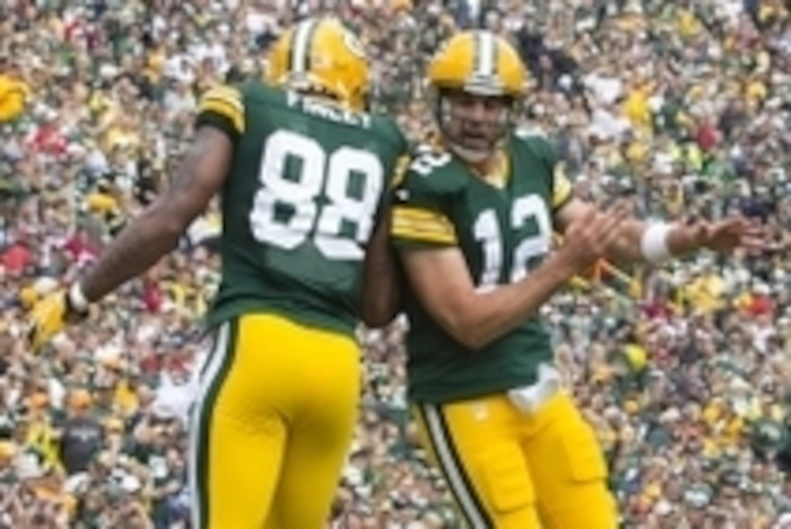 Sep 15, 2013; Green Bay, WI, USA; Green Bay Packers tight end Jermichael Finley (88) and quarterback Aaron Rodgers (12) celebrate a touchdown during the second quarter against the Washington Redskins at Lambeau Field. Mandatory Credit: Jeff Hanisch-USA T Sep 15, 2013; Green Bay, WI, USA; Green Bay Packers tight end Jermichael Finley (88) and quarterback Aaron Rodgers (12) celebrate a touchdown during the second quarter against the Washington Redskins at Lambeau Field. Mandatory Credit: Jeff Hanisch-USA T