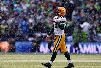 SEATTLE, WA - JANUARY 18: Aaron Rodgers #12 of the Green Bay Packers reacts after throwing an interception during the first half of the 2015 NFC Championship game against the Seattle Seahawks at CenturyLink Field on January 18, 2015 in Seattle, Washington