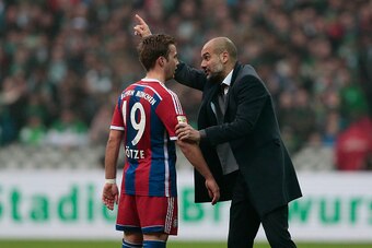 BREMEN, GERMANY - MARCH 14:  Head coach Pep Guardiola (R) of Munich talks to Mario Goetze (L) during the First Bundesliga match between SV Werder Bremen and FC Bayern Muenchen at Weserstadion on March 14, 2015 in Bremen, Germany.  (Photo by Oliver Hardt/G