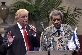 Republican presidential nominee Donald Trump (L) speaks during the Midwest Vision and Values Pastors and Leadership Conference next to boxing promoter Don King at the New Spirit Revival Center in Cleveland Heights, Ohio on September 21, 2016. / AFP / MAND