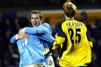 LONDON, UNITED KINGDOM:  Manchester City players Richard Dunne (C) and Sylvain Distin (L) celebrate as goalkeeper Arni Arason (R) joins them at the final whistle against Tottenham Hotspur during the F.A. Cup 4th Round Replay match at White Hart Lane in Lo