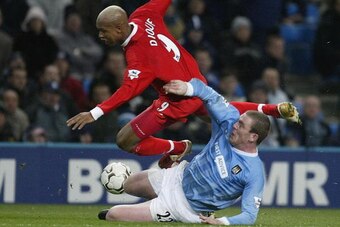 MANCHESTER, ENGLAND - DECEMBER 28:  El Hadji Diouf of Liverpool flies over Richard Dunne of Manchester City during the FA Barclaycard Premiership match between Manchester City and Liverpool at the City of Manchester Stadium on December 28, 2003 in Manches