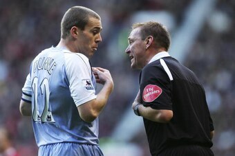 MANCHESTER, UNITED KINGDOM - DECEMBER 09: Referee Graham Poll has words with Richard Dunne of Manchester City during the Barclays Premiership match between Manchester United and Manchester City at Old Trafford on December 9, 2006 in Manchester, England. (