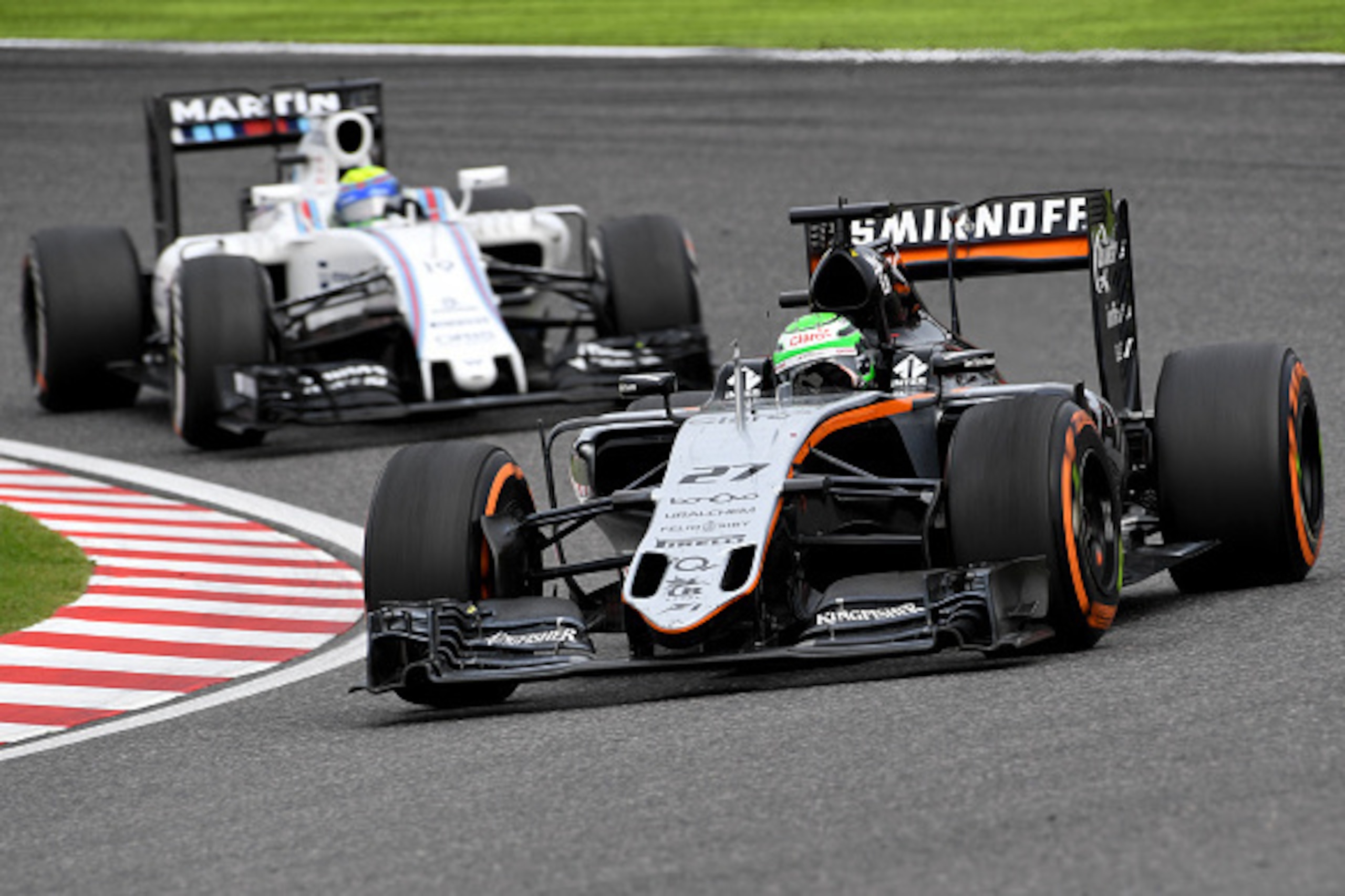 Sahara Force India F1 Team's German driver Nico Hulkenberg (R) leads Williams Martini Racing's Brazilian driver Felipe Massa (L) at the Formula One Japanese Grand Prix in Suzuka on October 9, 2016. / AFP / TOSHIFUMI KITAMURA        (Photo credit should re