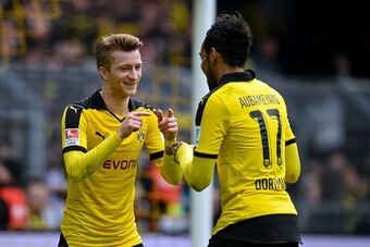 Dortmund's Gabonese striker Pierre-Emerick Aubameyang celebrates with Dortmund's striker Marco Reus scoring the 4-0 goal during the German first division Bundesliga football match Borussia Dortmund vs VfL Wolfsburg, in Dortmund, western Germany, on April 