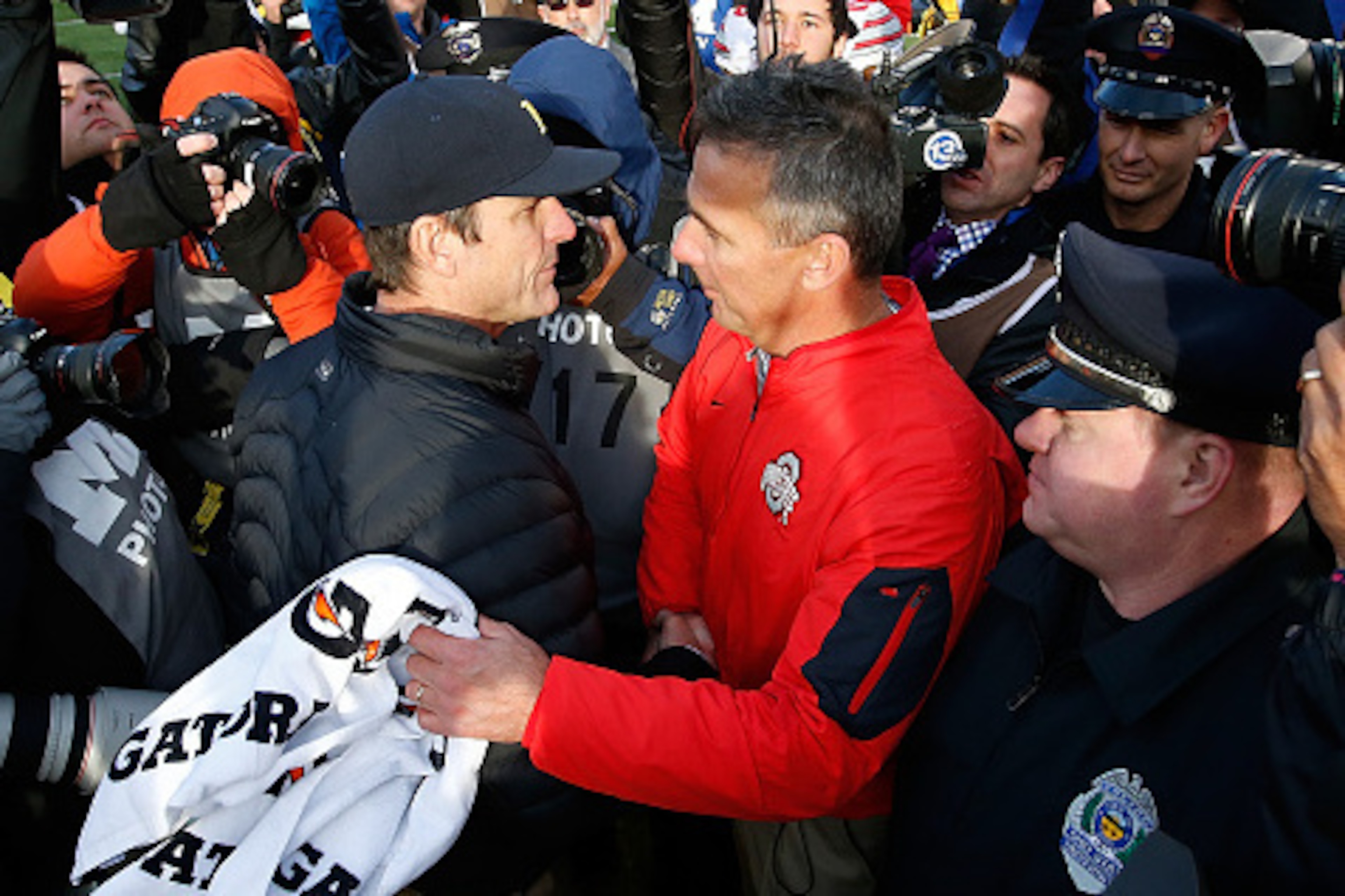 ANN ARBOR, MI - NOVEMBER 28: Head coach Urban Meyer of the Ohio State Buckeyes shakes hands with head coach Jim Harbaugh of the Michigan Wolverines after a 42-13 Ohio State win at Michigan Stadium on November 28, 2015 in Ann Arbor, Michigan. (Photo by G ANN ARBOR, MI - NOVEMBER 28: Head coach Urban Meyer of the Ohio State Buckeyes shakes hands with head coach Jim Harbaugh of the Michigan Wolverines after a 42-13 Ohio State win at Michigan Stadium on November 28, 2015 in Ann Arbor, Michigan. (Photo by G
