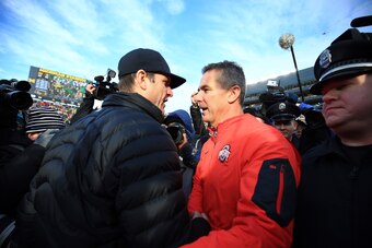 ANN ARBOR, MI - NOVEMBER 28: Head coach Urban Meyer of the Ohio State Buckeyes and head coach Jim Harbaugh of the Michigan Wolverines after the game against the Michigan Wolverines at Michigan Stadium on November 28, 2015 in Ann Arbor, Michigan. Ohio Stat