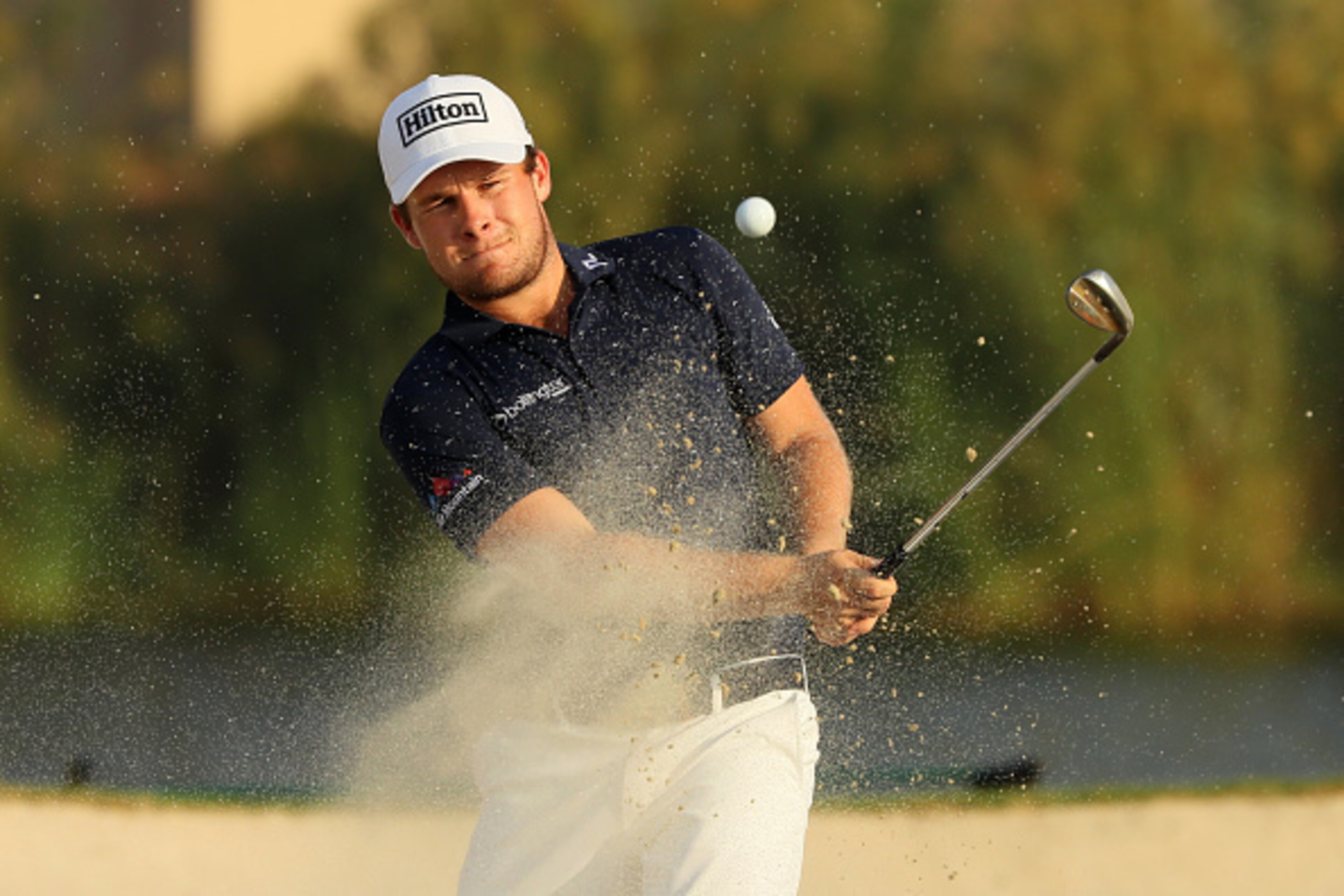 DUBAI, UNITED ARAB EMIRATES - NOVEMBER 20:  Tyrrell Hatton of England hits his third shot on the 17th hole for par during day four of the DP World Tour Championship at Jumeirah Golf Estates on November 20, 2016 in Dubai, United Arab Emirates.  (Photo by A