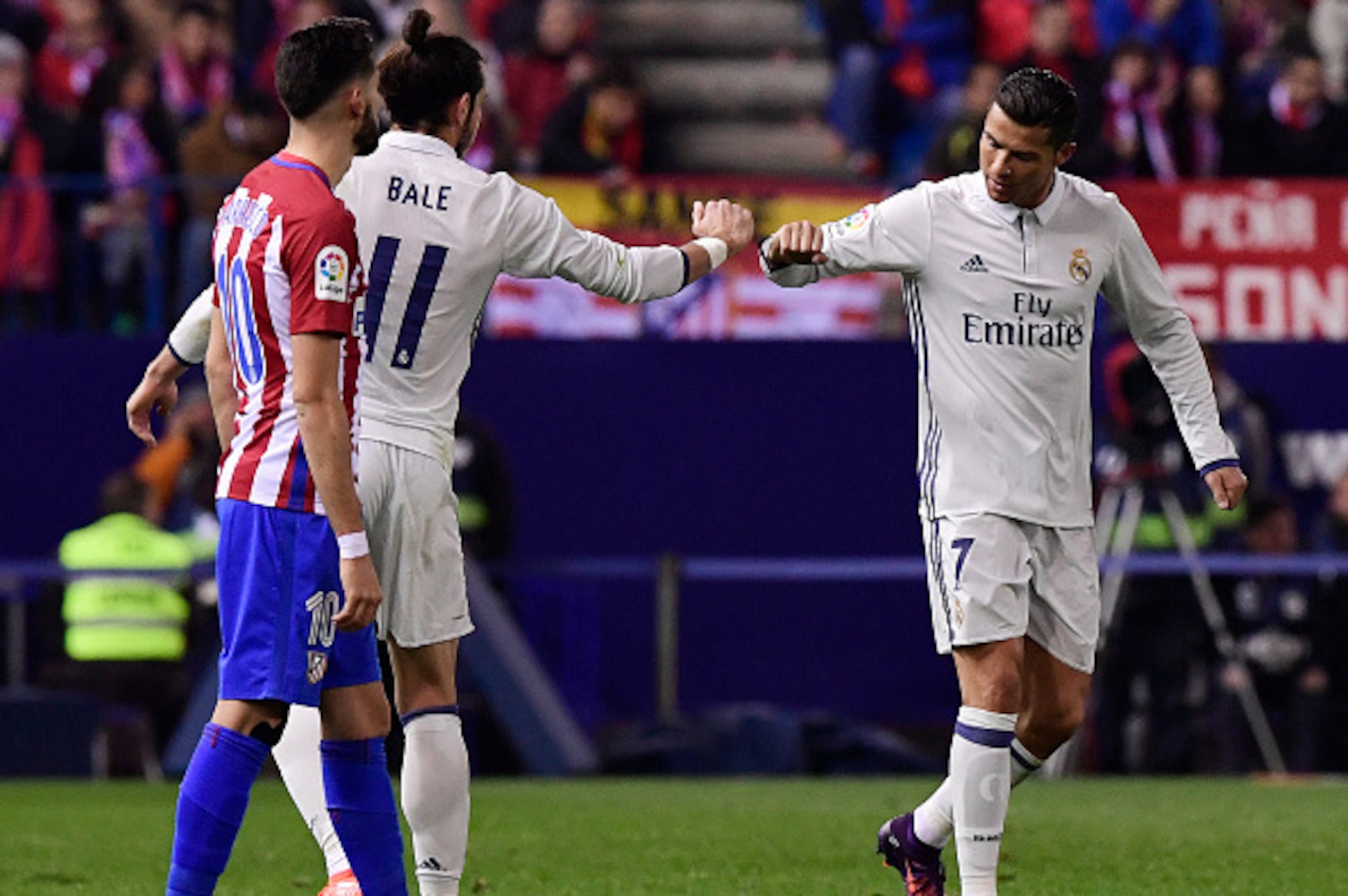TOPSHOT - Real Madrid's Portuguese forward Cristiano Ronaldo (R) celebrates a goal with Real Madrid's Welsh forward Gareth Bale during the Spanish league football match between Club Atletico de Madrid and Real Madrid CF at the Vicente Calderon stadium in 