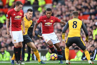 Manchester United's Ecuadorian midfielder Antonio Valencia (C) vies against Arsenal's Welsh midfielder Aaron Ramsey (R) and Arsenal's French defender Laurent Koscielny (2L) during the English Premier League football match between Manchester United and Ars