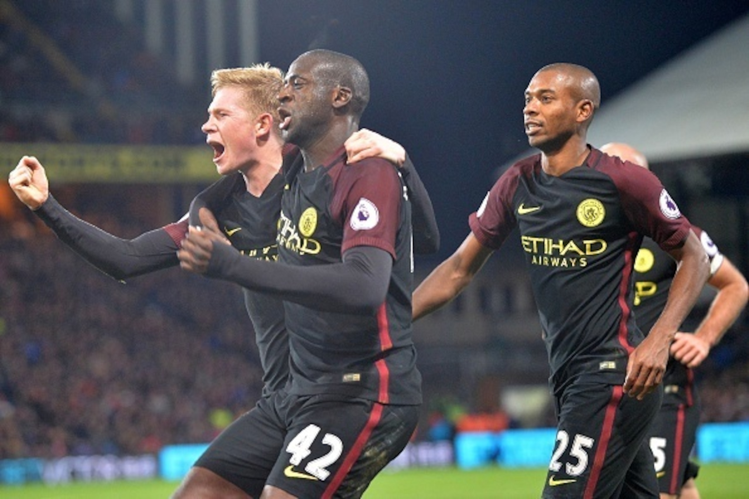 Manchester City's Ivorian midfielder Yaya Toure (C) celebrates with Manchester City's Belgian midfielder Kevin De Bruyne (L) and Manchester City's Brazilian midfielder Fernandinho (R) after scoring their second goal during the English Premier League footb