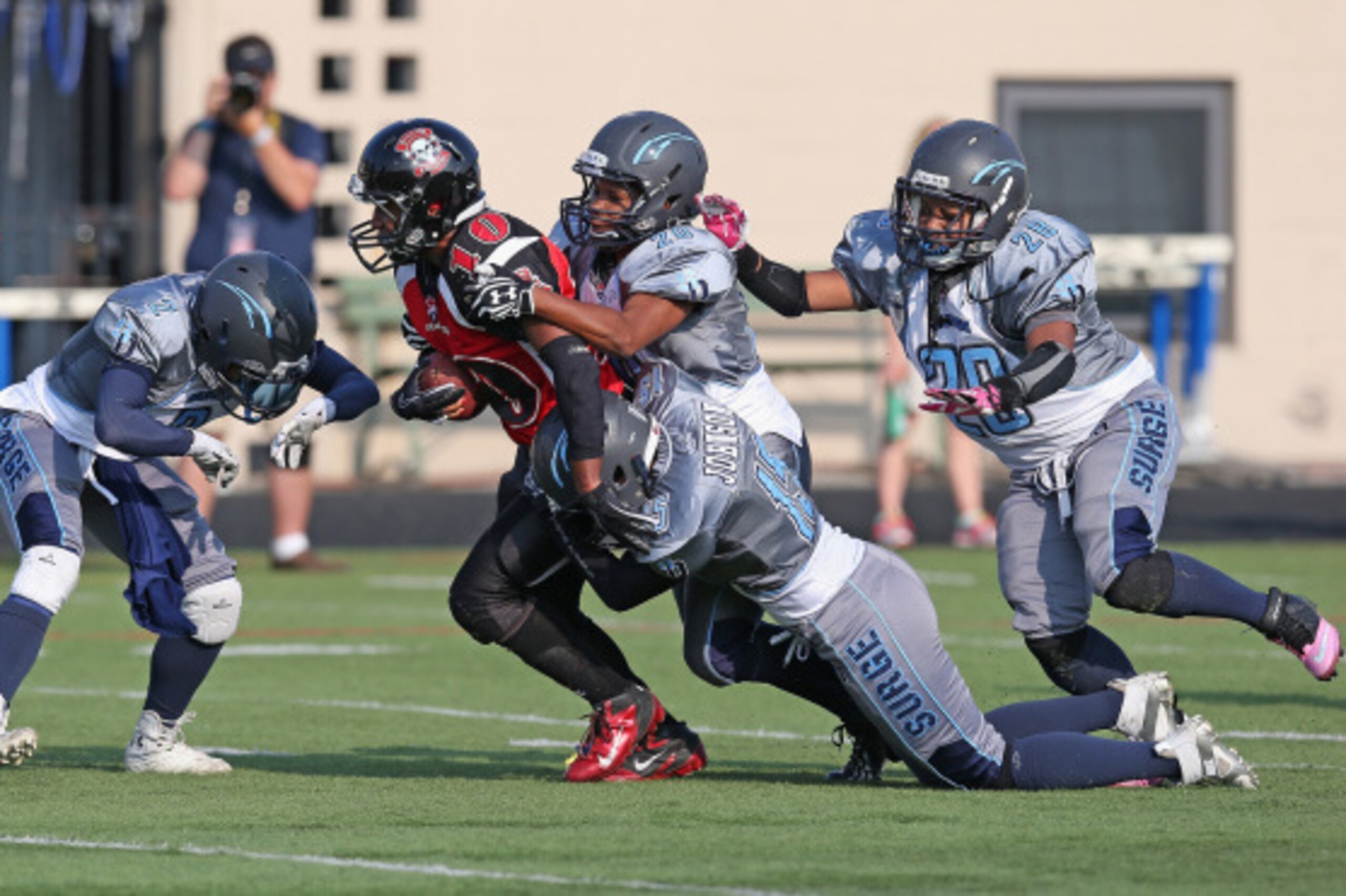 CHICAGO, IL - AUGUST 02: Adrienne Smith #10 of the Boston Militia is gang-tackled by (L-R) Sonfre Roberson #2, Alicia Freeman #20, Natasha Johnson #15 and Tiffany Humphrey #29 of the San Diego Surge during the Women's Football Alliance National Championsh