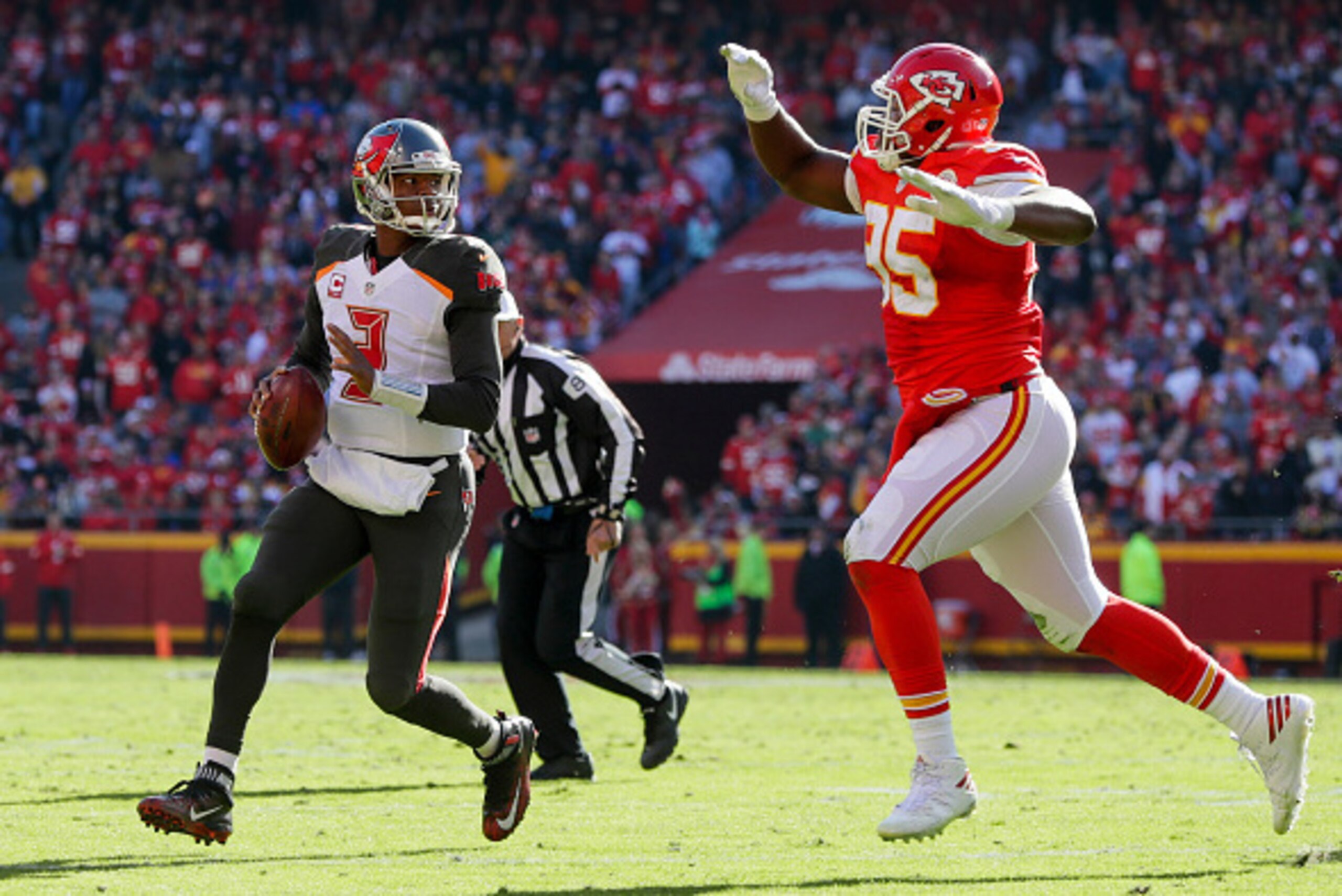 KANSAS CITY, MO - NOVEMBER 20: quarterback Jameis Winston #3 of the Tampa Bay Buccaneers rolls out to pass while being pursued by defensive end Chris Jones #95 of the Kansas City Chiefs at Arrowhead Stadium during the second quarter of the game on Novembe