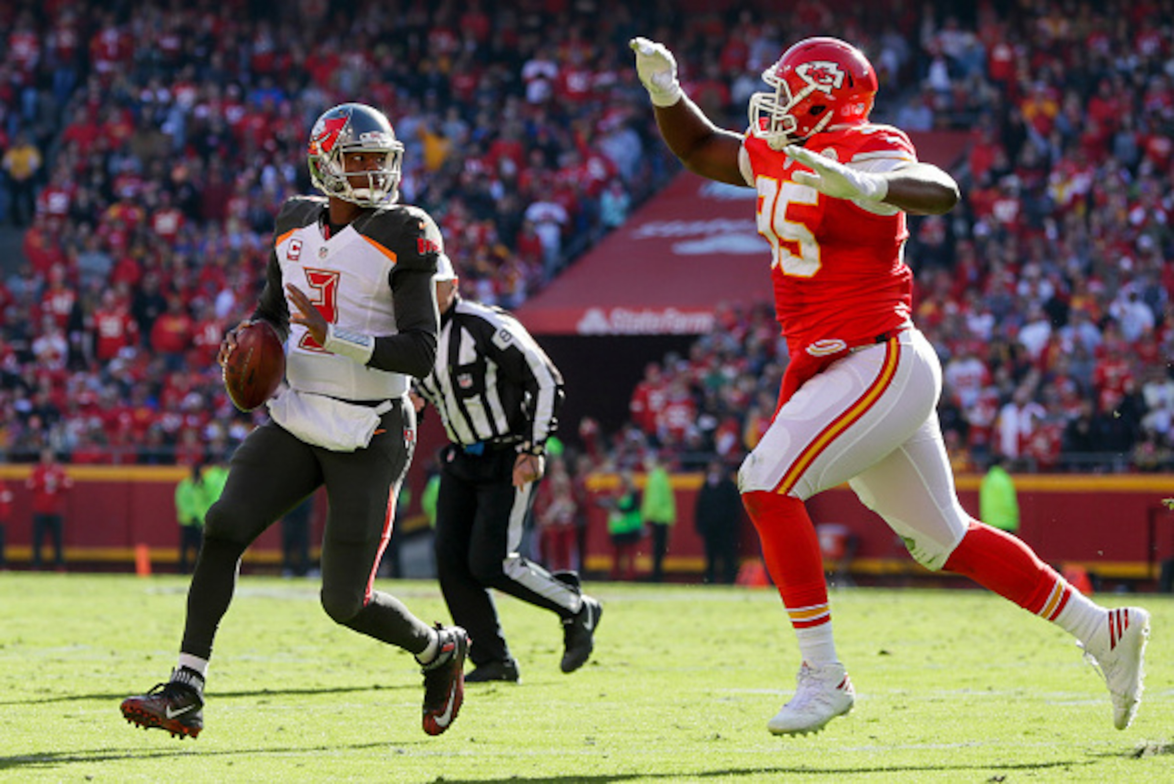 KANSAS CITY, MO - NOVEMBER 20: quarterback Jameis Winston #3 of the Tampa Bay Buccaneers rolls out to pass while being pursued by defensive end Chris Jones #95 of the Kansas City Chiefs at Arrowhead Stadium during the second quarter of the game on Novembe