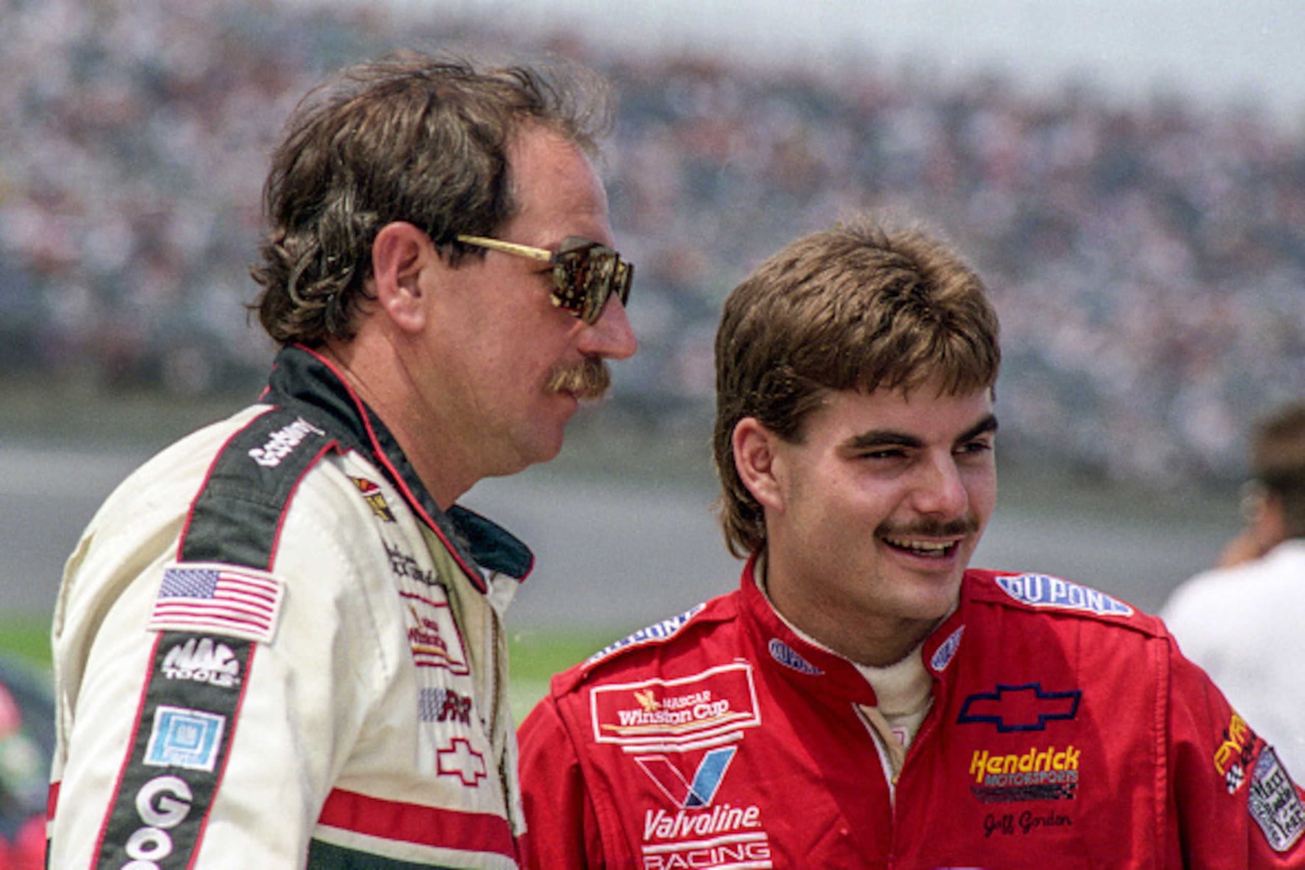 DAYTONA BEACH, FL - JULY 1993: Jeff Gordon (R) talks with Dale Earnhardt Sr. at Daytona International Speedway circa July 1993 in Daytona Beach, Florida.  (Photo by Brian Cleary/Getty Images)