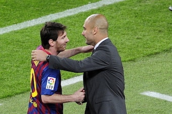 Barcelona's Argentinian forward Lionel Messi (L) celebrates with Barcelona's coach Josep Guardiola after scoring a goal during the Spanish league football match FC Barcelona vs RCD Espanyol on May 5, 2012 at the Camp Nou stadium in Barcelona. AFP PHOTO/ J