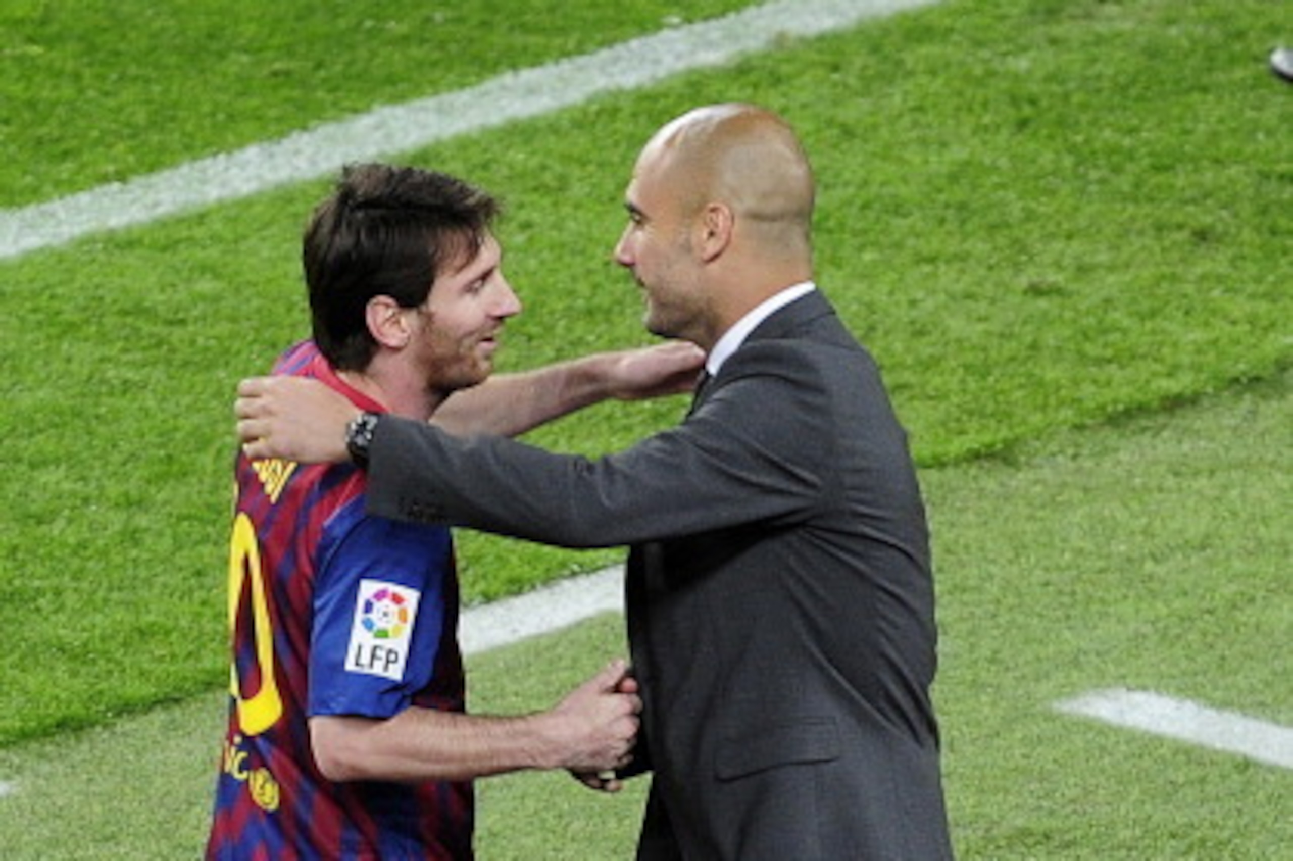 Barcelona's Argentinian forward Lionel Messi (L) celebrates with Barcelona's coach Josep Guardiola after scoring a goal during the Spanish league football match FC Barcelona vs RCD Espanyol on May 5, 2012 at the Camp Nou stadium in Barcelona. AFP PHOTO/ J
