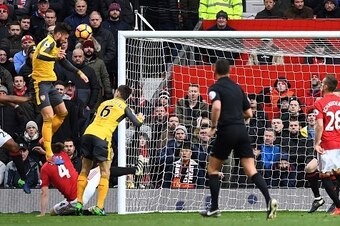 Arsenal's French striker Olivier Giroud (3L) jumps to score his team's first goal during the English Premier League football match between Manchester United and Arsenal at Old Trafford in Manchester, north west England, on November 19, 2016. / AFP / Paul 