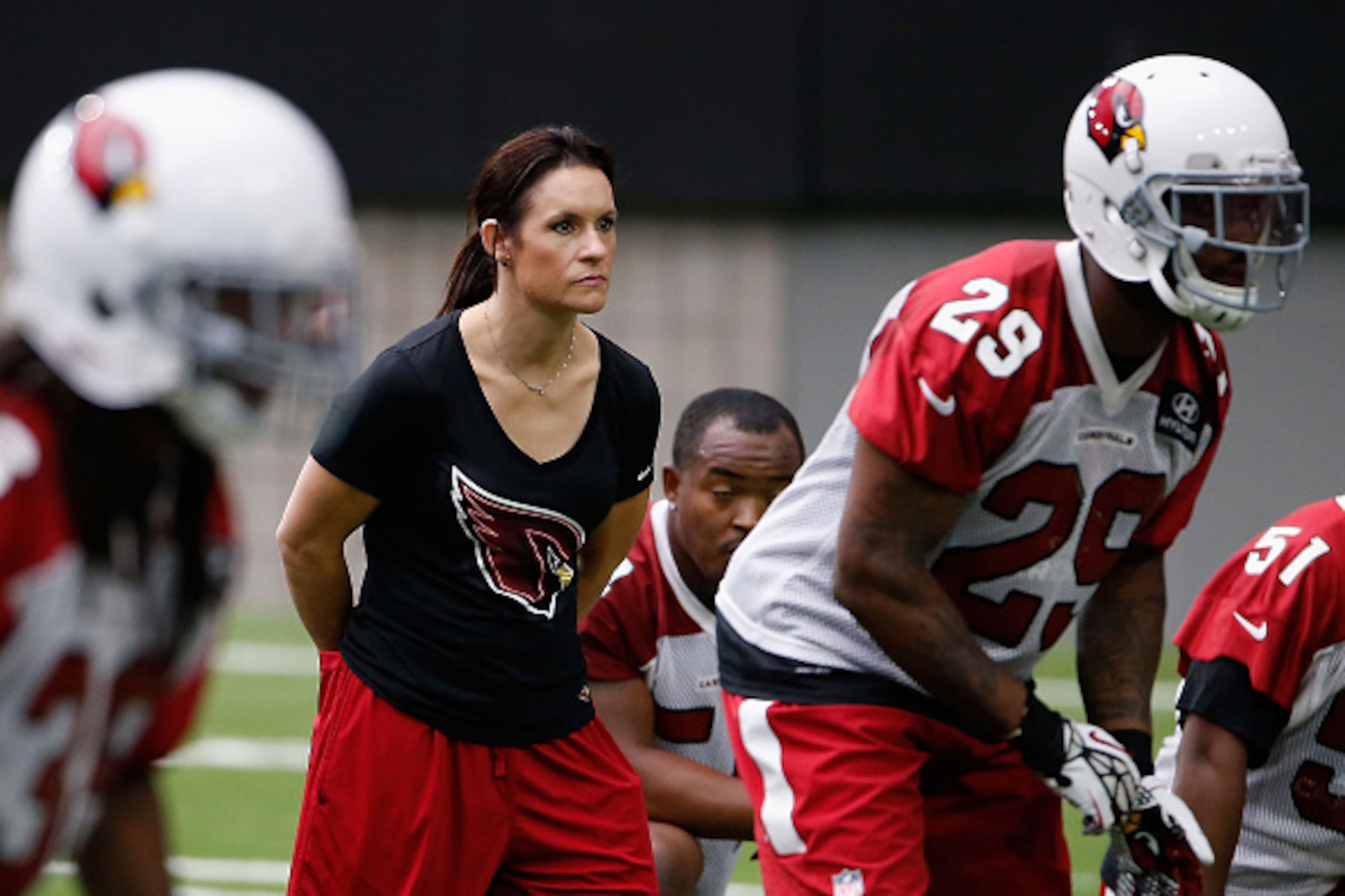 GLENDALE, AZ - AUGUST 01:  Training camp coach Jen Welter of the Arizona Cardinals participates in on-field drills during a team training camp at University of Phoenix Stadium on August 1, 2015 in Glendale, Arizona.  (Photo by Christian Petersen/Getty Ima