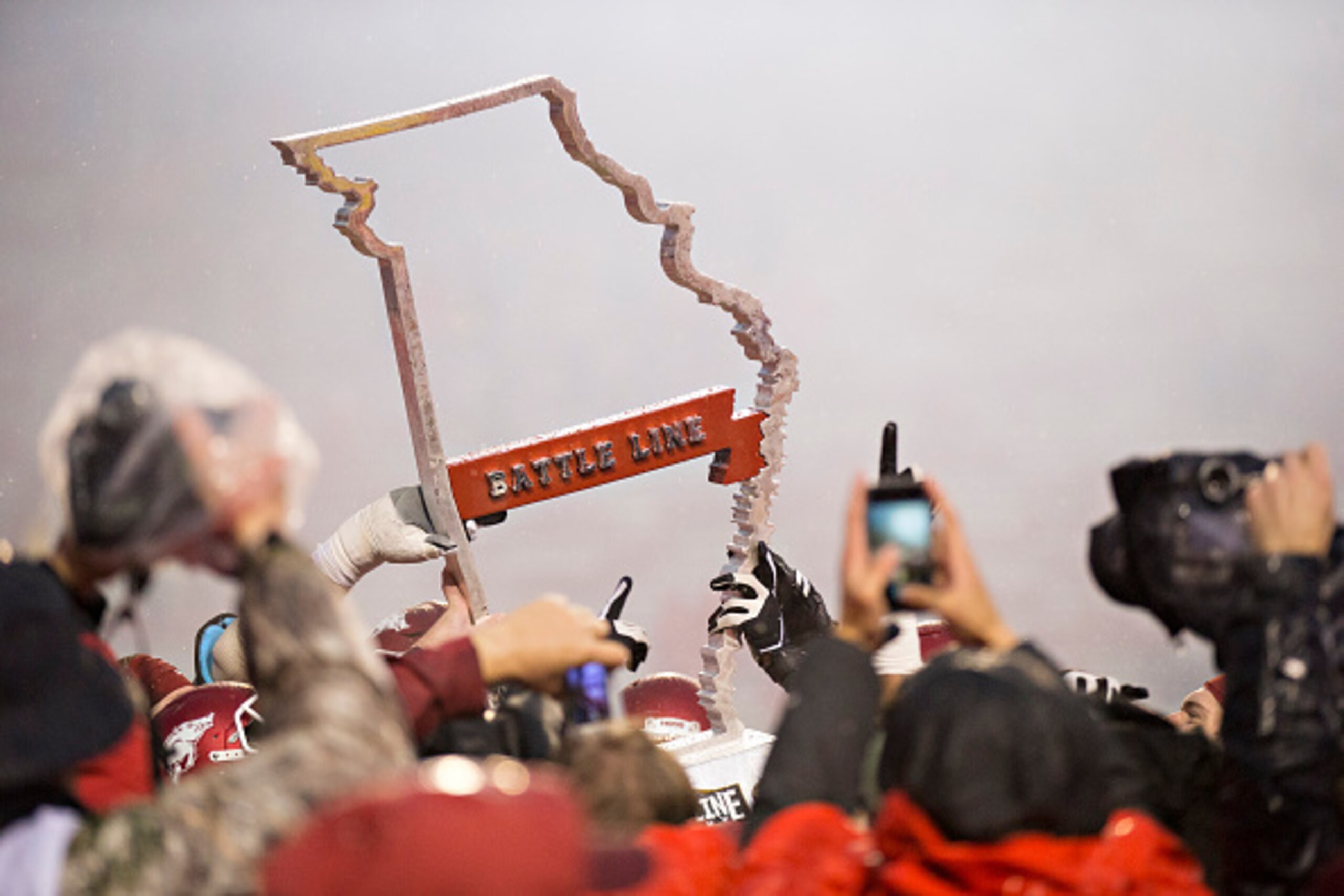 FAYETTEVILLE, AR - NOVEMBER 27:  Battle Line Trophy is raised by the Arkansas Razorbacks after a win against the Missouri Tigers at Razorback Stadium Stadium on November 27, 2015 in Fayetteville, Arkansas. The Razorbacks defeated the Tigers 28-3.   (Photo