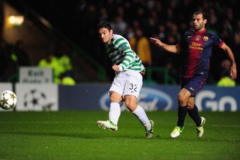 GLASGOW, SCOTLAND - NOVEMBER 07:  Celtic player Tony Watt (l) scores the second goal watched by Barcelona player Javier Mascherano during the UEFA Champions League Group G match between Celtic and Barcelona at Celtic Park on November 7, 2012 in Glasgow, S