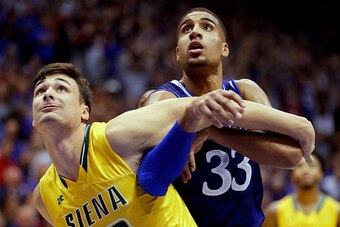 LAWRENCE, KS - NOVEMBER 18:  Evan Fisher #32 of the Siena Saints and Landen Lucas #33 of the Kansas Jayhawks battle for a rebound during the game at Allen Fieldhouse on November 18, 2016 in Lawrence, Kansas.  (Photo by Jamie Squire/Getty Images)