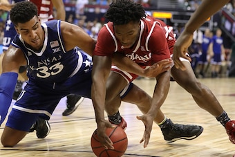 HONOLULU, HI - NOVEMBER 11: Landen Lucas #33 of the Kansas Jayhawks and Freddie McSwain Jr. #21 of the Indiana Hoosiers go after a loose ball during the first half of the second game of the Armed Forces Classic at the Stan Sheriff Center on November 11, 2