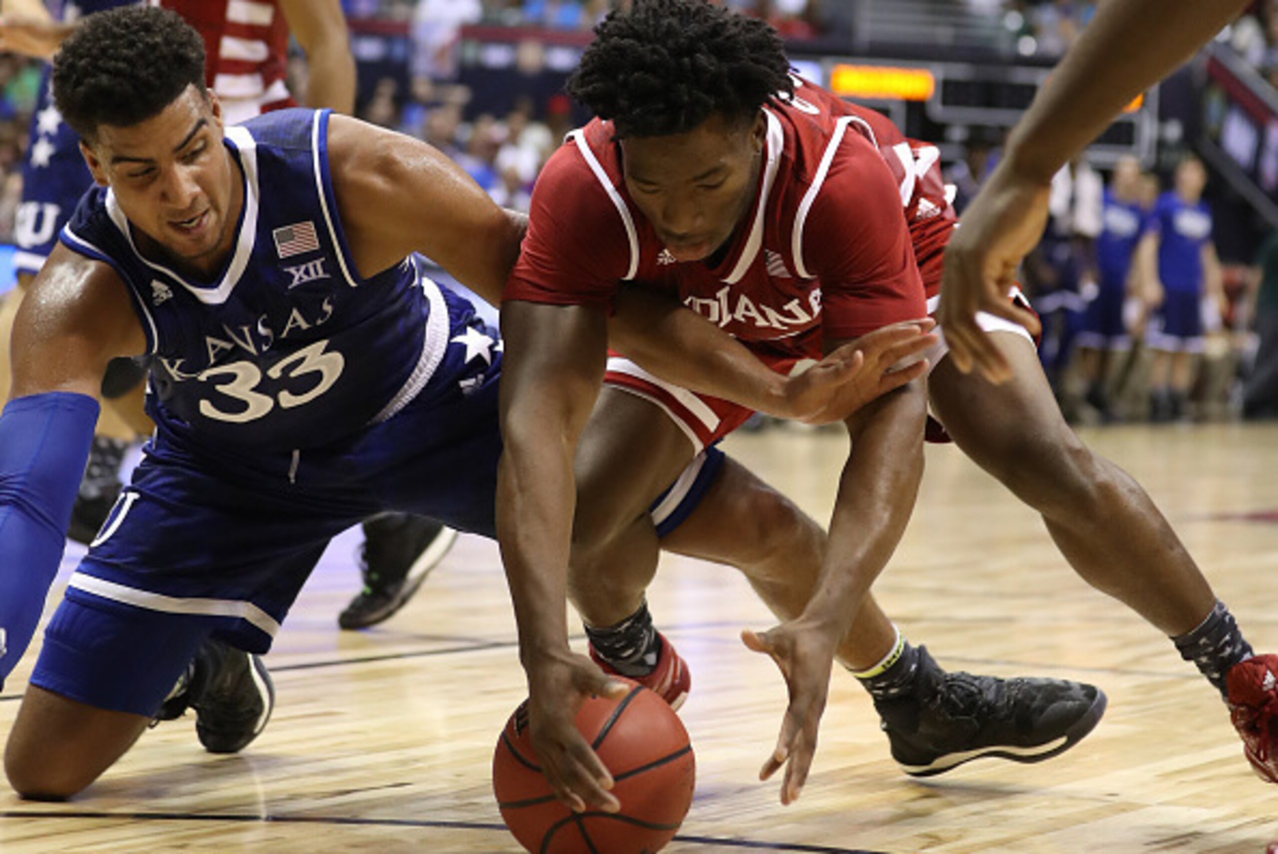 HONOLULU, HI - NOVEMBER 11: Landen Lucas #33 of the Kansas Jayhawks and Freddie McSwain Jr. #21 of the Indiana Hoosiers go after a loose ball during the first half of the second game of the Armed Forces Classic at the Stan Sheriff Center on November 11, 2