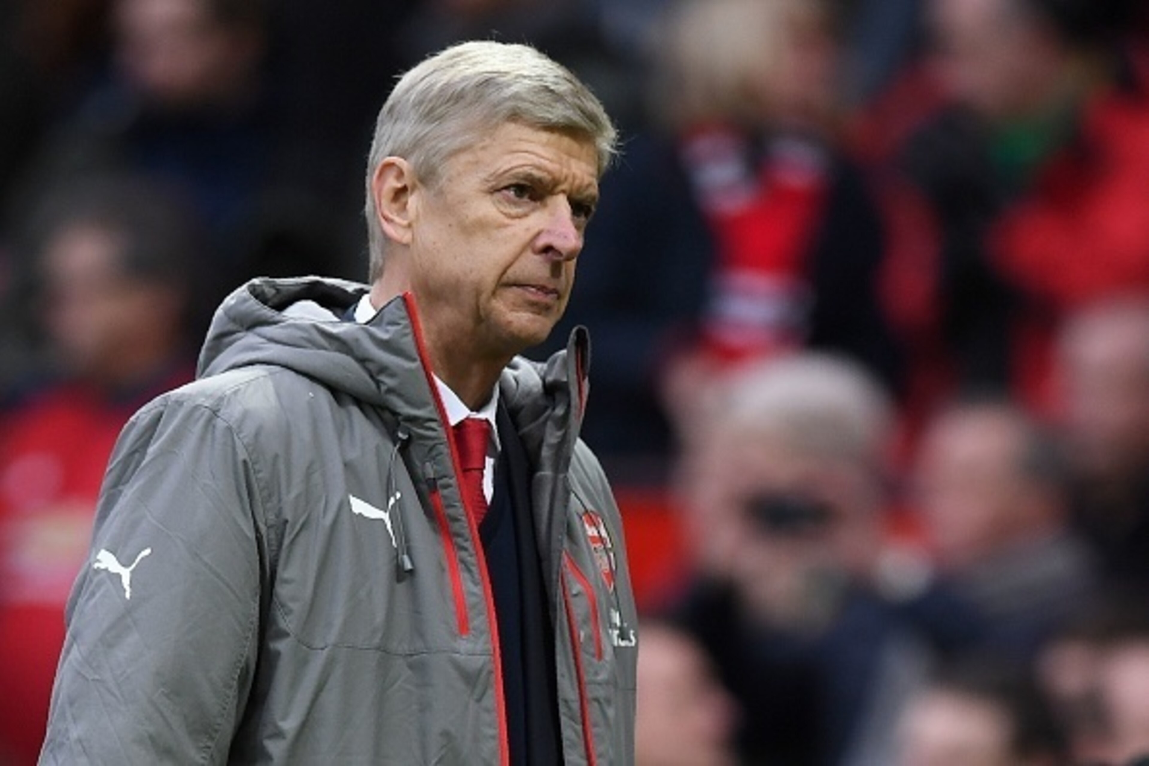 Arsenal's French manager Arsene Wenger leaves the pitch following the English Premier League football match between Manchester United and Arsenal at Old Trafford in Manchester, north west England, on November 19, 2016.
The match ended in a draw at 1-1. / 