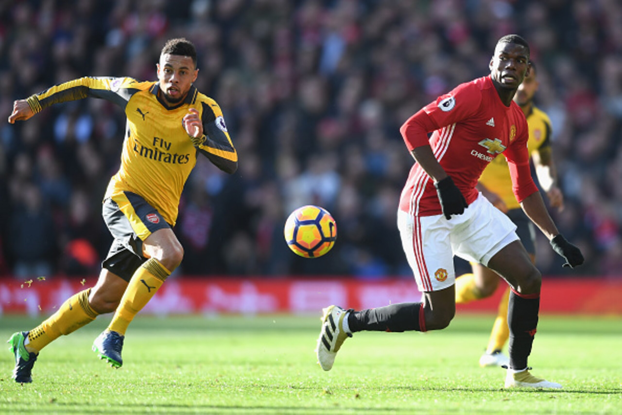 MANCHESTER, ENGLAND - NOVEMBER 19: Francis Coquelin of Arsenal (L) and Paul Pogba of Manchester United (R) both attempt to get to the ball during the Premier League match between Manchester United and Arsenal at Old Trafford on November 19, 2016 in Manche