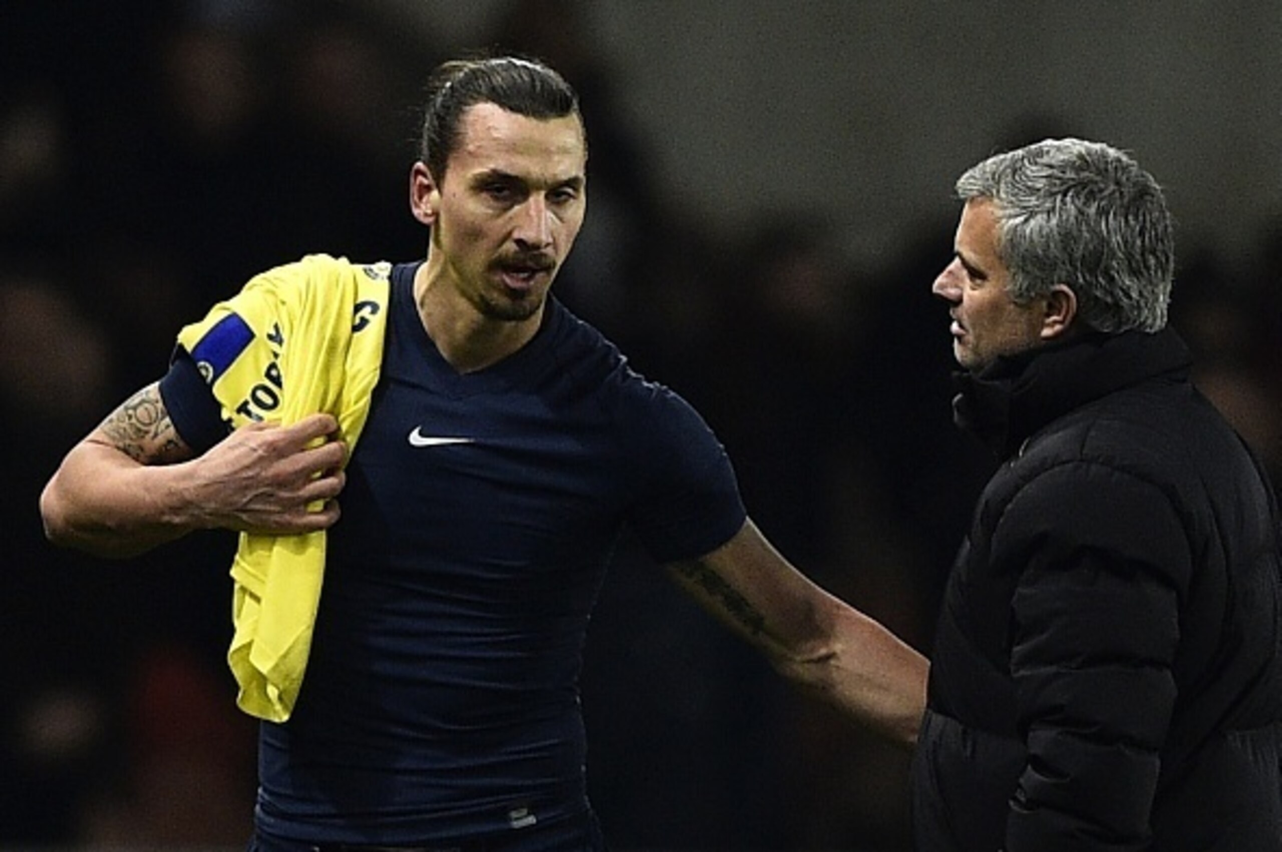 Paris Saint-Germain's Swedish midfielder Zlatan Ibrahimovic speaks with Chelsea's Portuguese manager Jose Mourinho (R) at the end of the UEFA Champions League round of 16 football match between Paris Saint-Germain (PSG) and Chelsea at the Parc des Princes