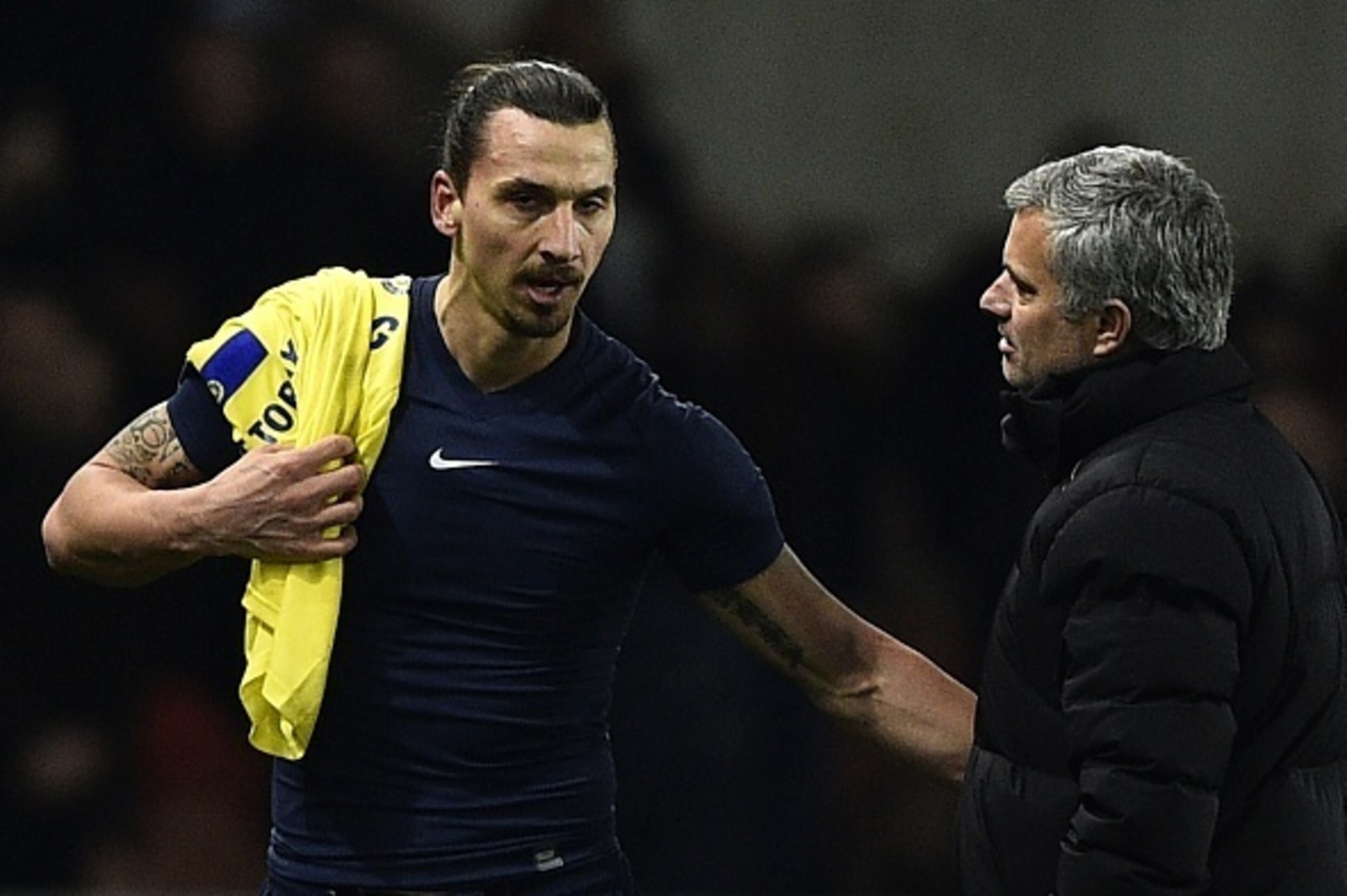 Paris Saint-Germain's Swedish midfielder Zlatan Ibrahimovic speaks with Chelsea's Portuguese manager Jose Mourinho (R) at the end of the UEFA Champions League round of 16 football match between Paris Saint-Germain (PSG) and Chelsea at the Parc des Princes