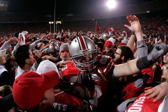 COLUMBUS, OH - NOVEMBER 18:  Andrew Moses #66 of the Ohio State Buckeyes celebrates with fans and players on the field after Ohio State's 42-39 win against the Michigan Wolverines November 18, 2006 at Ohio Stadium in Columbus, Ohio.  (Photo by Gregory Sha