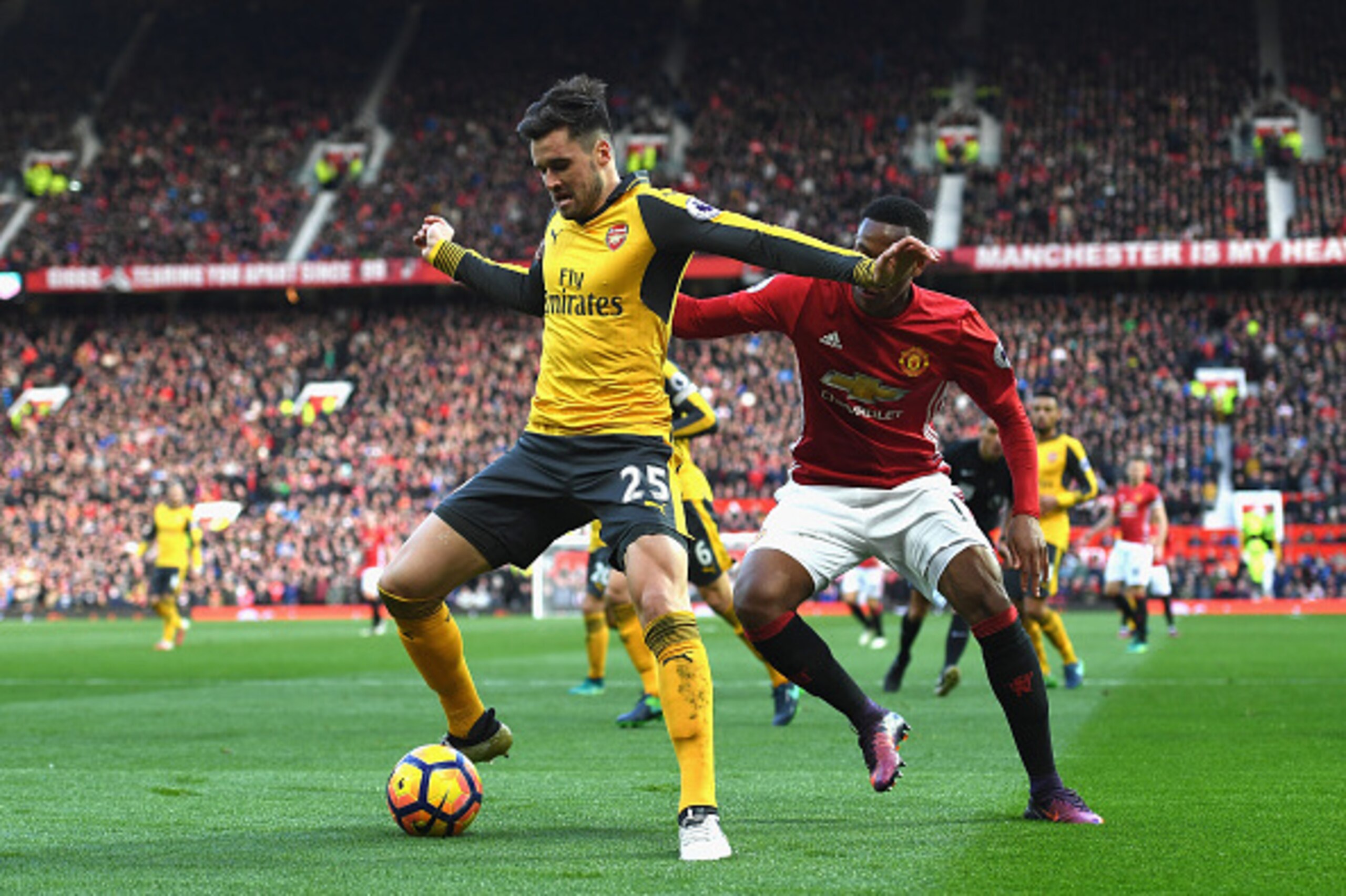 MANCHESTER, ENGLAND - NOVEMBER 19: Carl Jenkinson of Arsenal (L) is put under pressure from Anthony Martial of Manchester United (R) during the Premier League match between Manchester United and Arsenal at Old Trafford on November 19, 2016 in Manchester, 