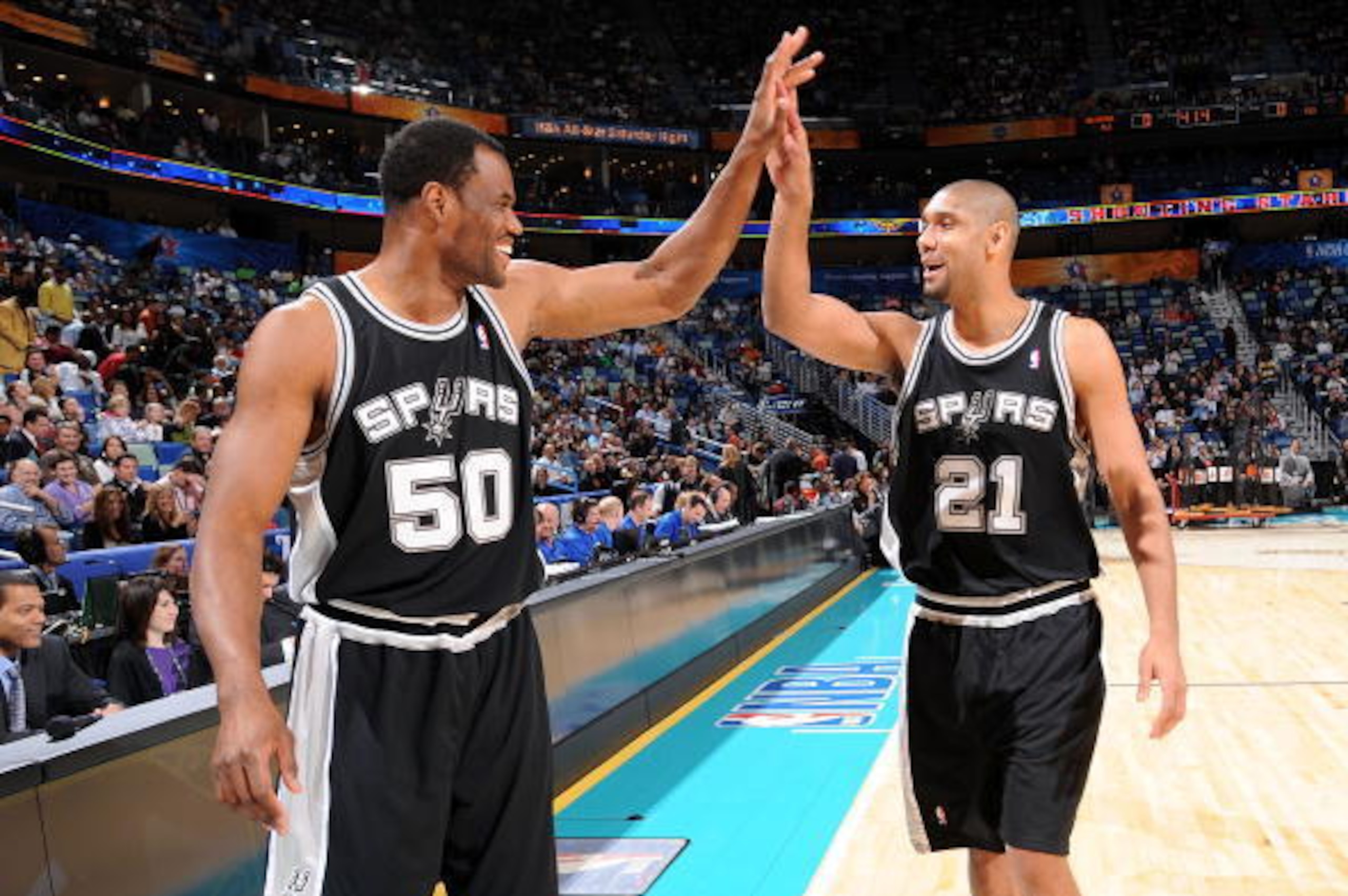 NEW ORLEANS - FEBRUARY 16:  Former San Antonio Spur David Robinson and Tim Duncan #21 of the Spurs celebrate during the Haier Shooting Stars part of 2008 NBA All-Star Weekend at the New Orleans Arena on February 16, 2008 in New Orleans, Louisiana.  NOTE T