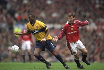 14 Mar 1998:  Patrick Vieira (left) of Arsenal gets away from Teddy Sheringham of Manchester United during an FA Carling Premiership match at Old Trafford in Manchester, England. Arsenal won the match 1-0. \ Mandatory Credit: Shaun  Botterill/Allsport