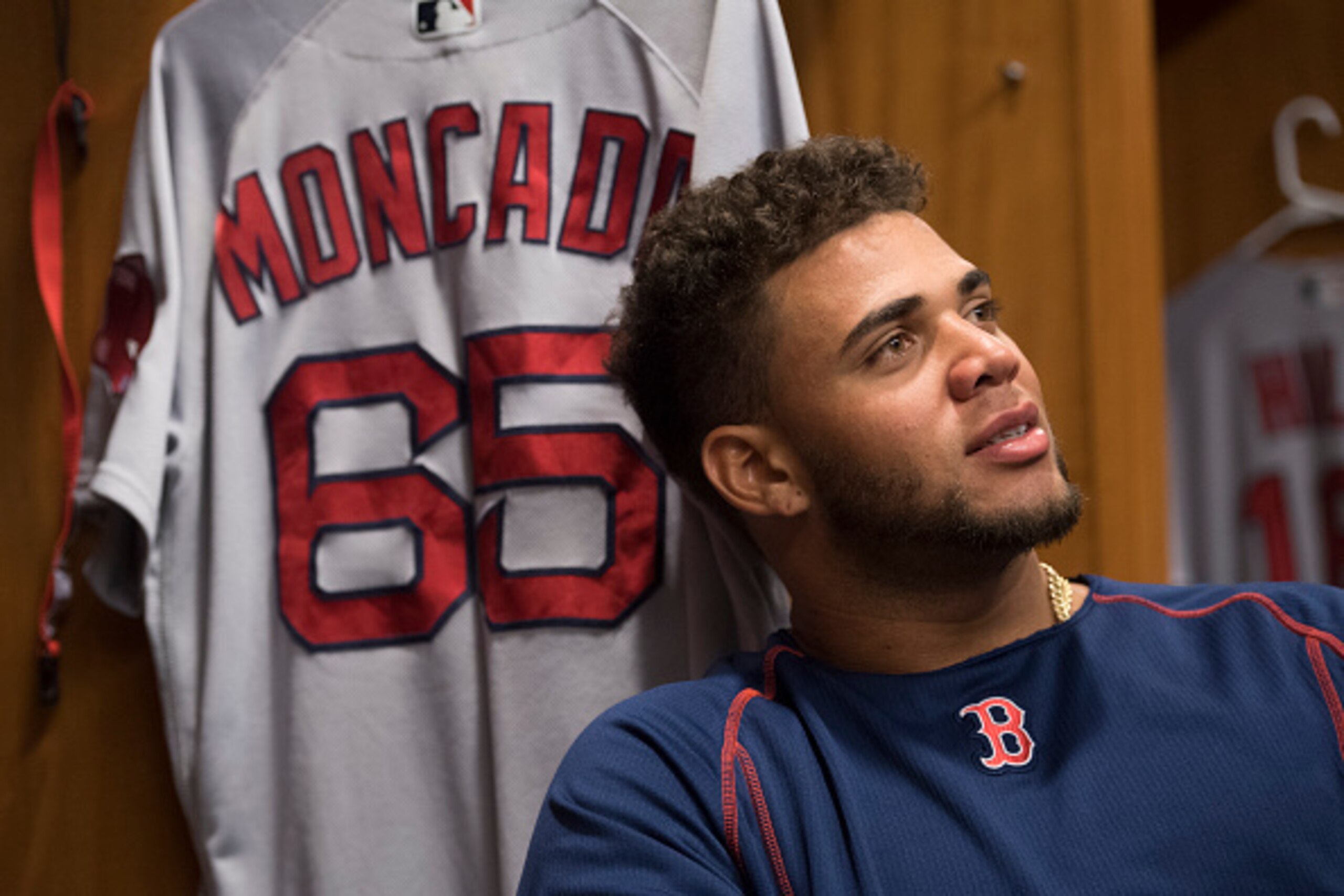 NEW YORK, NY - SEPTEMBER 28:  Yoan Moncada #65 of the Boston Red Sox sits at his locker before a game against the New York Yankees at Yankee Stadium on September 28, 2016 in the Bronx borough of New York City.  (Photo by Michael Ivins/Boston Red Sox/Getty