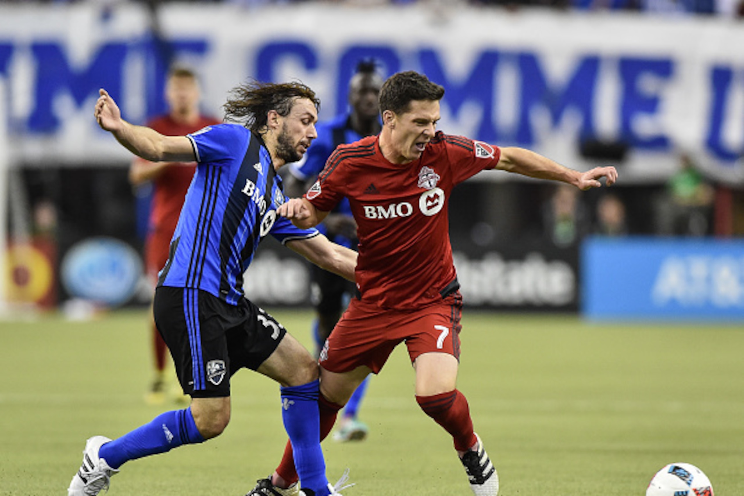 MONTREAL, QC - NOVEMBER 22: Marco Donadel #33 of the Montreal Impact and Will Johnson #7 of the Toronto FC battle for the ball during leg one of the MLS Eastern Conference finals at Olympic Stadium on November 22, 2016 in Montreal, Quebec, Canada. The M MONTREAL, QC - NOVEMBER 22: Marco Donadel #33 of the Montreal Impact and Will Johnson #7 of the Toronto FC battle for the ball during leg one of the MLS Eastern Conference finals at Olympic Stadium on November 22, 2016 in Montreal, Quebec, Canada. The M