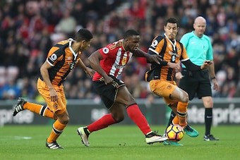 SUNDERLAND, ENGLAND - NOVEMBER 19: Victor Anichebe of Sunderland (C) holds off Curtis Davies of Hull City (L) and Jake Livermore of Hull City (R) during the Premier League match between Sunderland and Hull City at Stadium of Light on November 19, 2016 in 