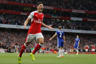 Arsenal's German midfielder Mesut Ozil celebrates scoring their third goal during the English Premier League football match between Arsenal and Chelsea at The Emirates stadium in London, on September 24, 2016. / AFP / IKIMAGES / Ian Kington / RESTRICTED T