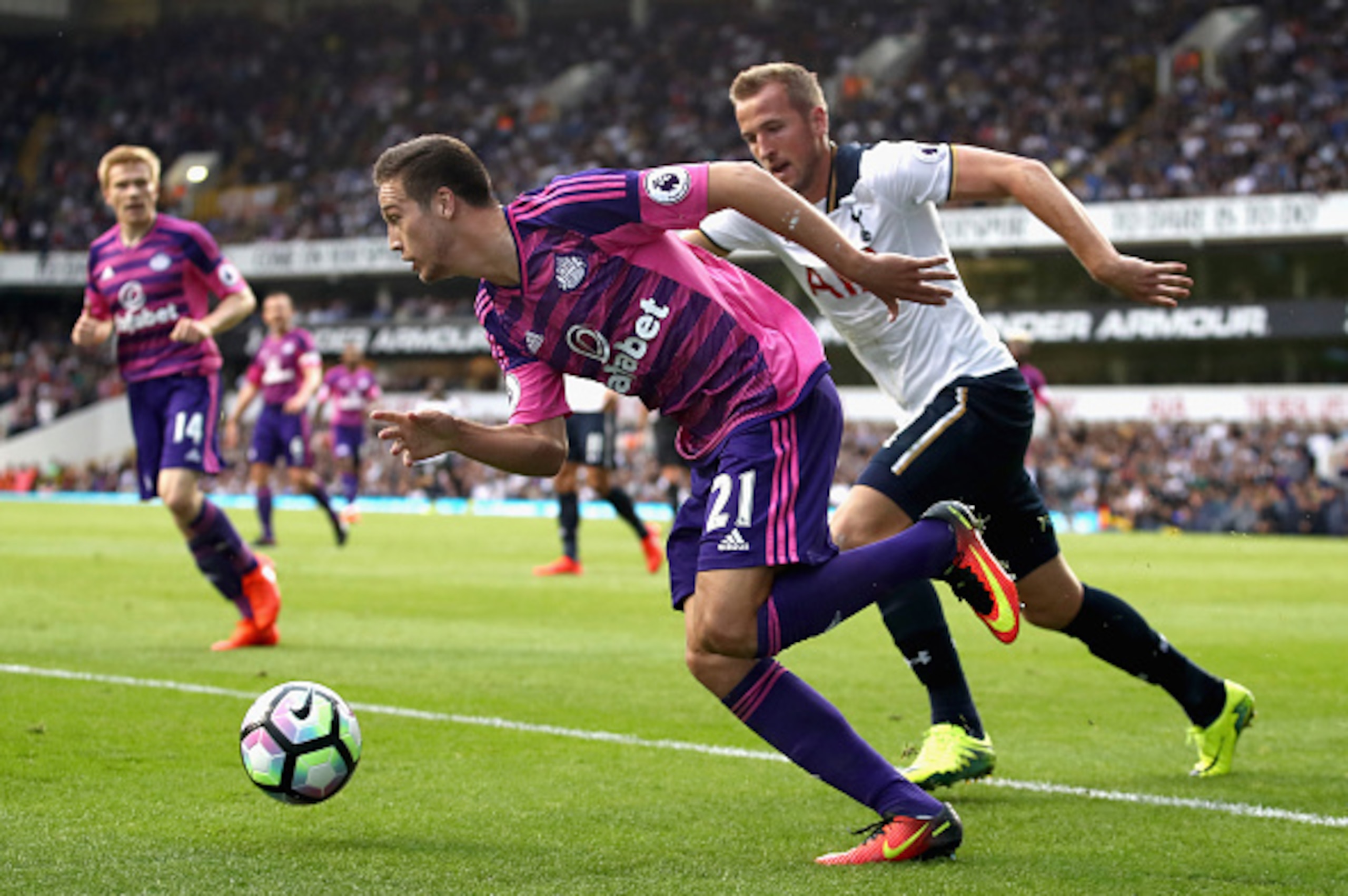 LONDON, ENGLAND - SEPTEMBER 18: Javier Manquillo of Sunderland attempts to take the ball past Harry Kane of Tottenham Hotspur  during the Premier League match between Tottenham Hotspur and Sunderland at White Hart Lane on September 18, 2016 in London, Eng