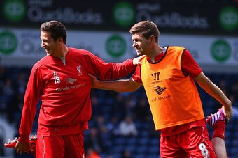 WEST BROMWICH, ENGLAND - APRIL 25:  Javi Manquillo and Steven Gerrard of Liverpool stretch during the Barclays Premier League match between West Bromwich Albion and Liverpool at The Hawthorns on April 25, 2015 in West Bromwich, England.  (Photo by Matthew