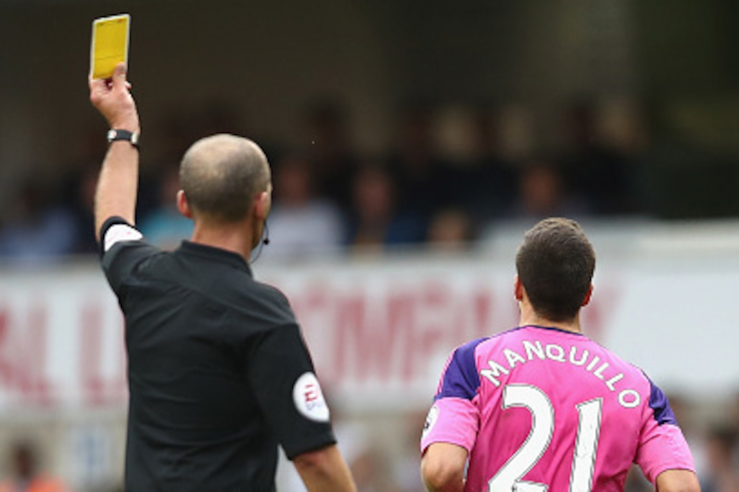 LONDON, ENGLAND - SEPTEMBER 18: Mike Dean gives Javier Manquillo of Sunderland a yellow card  during the Premier League match between Tottenham Hotspur and Sunderland at White Hart Lane on September 18, 2016 in London, England.  (Photo by Julian Finney/Ge